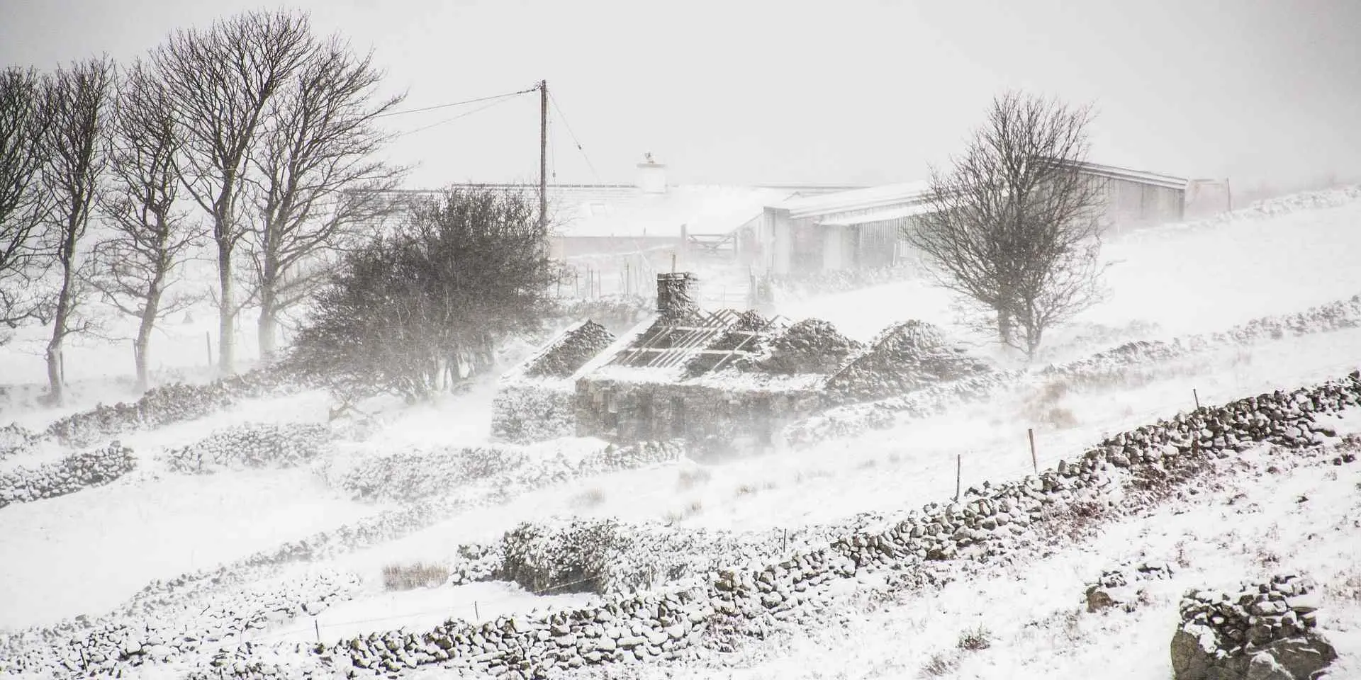 Derelict cottage and farm under snow